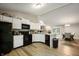 Bright kitchen with white cabinets, granite countertops, and access to dining area at 5873 N Victoria Dr, Indianapolis, IN 46228