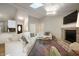 Bright living room featuring a brick fireplace, skylight, and comfortable seating at 5873 N Victoria Dr, Indianapolis, IN 46228