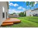 Well-maintained backyard features a deck and mature landscaping at 6010 Lakeside Manor Ave, Indianapolis, IN 46254