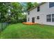 Fenced yard featuring a spacious lawn, mature trees and a wood deck at 6010 Lakeside Manor Ave, Indianapolis, IN 46254