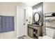 Modern bathroom with updated vanity, stylish mirror, and open shelving at 6010 Lakeside Manor Ave, Indianapolis, IN 46254