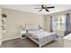 Bright bedroom with a ceiling fan, shelving, and a large window at 6010 Lakeside Manor Ave, Indianapolis, IN 46254