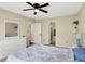 Sunlit bedroom boasts plush carpeting, a closet, and a dresser next to a window at 6010 Lakeside Manor Ave, Indianapolis, IN 46254