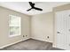 Cozy bedroom with natural light, neutral walls, carpet, and ample closet space at 6010 Lakeside Manor Ave, Indianapolis, IN 46254