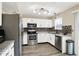 Well-appointed kitchen featuring stainless steel appliances, white cabinetry, new countertops, and stylish backsplash at 6010 Lakeside Manor Ave, Indianapolis, IN 46254