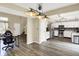 Modern kitchen with white cabinets, stainless steel appliances, and vinyl flooring opens to living spaces at 6010 Lakeside Manor Ave, Indianapolis, IN 46254