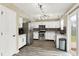 Modern kitchen featuring stainless steel appliances, white cabinetry, stylish backsplash, and new vinyl flooring at 6010 Lakeside Manor Ave, Indianapolis, IN 46254