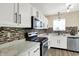 Well-lit kitchen featuring stainless steel appliances, granite countertops, and sleek black hardware at 6010 Lakeside Manor Ave, Indianapolis, IN 46254