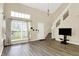 Spacious living room with high ceilings, large windows, new floors, and a staircase leading to the upper level at 6010 Lakeside Manor Ave, Indianapolis, IN 46254