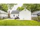 Home's backyard with patio and furniture set on a lush green lawn, perfect for outdoor entertaining and relaxing at 6040 Crittenden Ave, Indianapolis, IN 46220