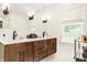 Bright bathroom featuring a double sink vanity, modern fixtures, and a window that brings in natural light at 6040 Crittenden Ave, Indianapolis, IN 46220