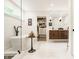 Bright bathroom with a soaking tub, glass shower, and wood vanity with and sinks at 6040 Crittenden Ave, Indianapolis, IN 46220