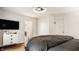 Bedroom with a white dresser, hardwood floors, and a comfy grey duvet at 6040 Crittenden Ave, Indianapolis, IN 46220