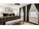 Stylish bedroom featuring hardwood floors, a metal bed frame and a bench at the foot of the bed at 6040 Crittenden Ave, Indianapolis, IN 46220