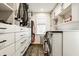 Spacious walk-in closet with custom shelving and a convenient laundry area including a washer and dryer at 6040 Crittenden Ave, Indianapolis, IN 46220