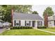 Well-maintained home with a brick chimney, nice landscaping, and a cozy, inviting curb appeal at 6040 Crittenden Ave, Indianapolis, IN 46220