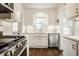 Bright kitchen with white cabinets, stainless steel appliances and a window over the sink at 6040 Crittenden Ave, Indianapolis, IN 46220