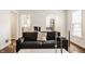 Inviting living room featuring hardwood floors, a comfortable sofa, and modern decor at 6040 Crittenden Ave, Indianapolis, IN 46220