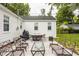 Inviting outdoor patio with ample seating, a grill, and a well-maintained yard, perfect for entertaining at 6040 Crittenden Ave, Indianapolis, IN 46220