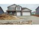 Charming two-story home with a two-car garage and a modern gray brick and siding facade at 6049 Madera Dr, Whitestown, IN 46075