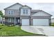 Charming two-story home with a two-car garage, landscaped yard, and a welcoming covered front porch at 6049 Madera Dr, Whitestown, IN 46075
