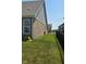 A spacious side yard with lush green grass between the homes at 6184 Farlin Dr, Whitestown, IN 46075