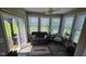 Bright sunroom with large windows, comfortable seating, and access to the outdoors at 6184 Farlin Dr, Whitestown, IN 46075