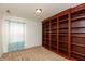 Bedroom featuring carpet, large wooden bookcase, and blue window covering at 6369 Clary Ln, Greenwood, IN 46143