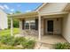 Inviting covered front porch with brick accents and well-maintained landscaping around the house at 6369 Clary Ln, Greenwood, IN 46143