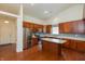 Spacious kitchen with stainless steel appliances, wood cabinets, an island, and a modern backsplash at 6369 Clary Ln, Greenwood, IN 46143