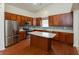Spacious kitchen with stainless steel appliances, wood cabinets, an island, and a modern backsplash at 6369 Clary Ln, Greenwood, IN 46143