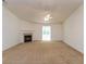 Spacious carpeted living room with a ceiling fan, fireplace, and an open floor plan bathed in natural light at 6369 Clary Ln, Greenwood, IN 46143