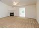 Bright and spacious carpeted living room featuring a cozy fireplace, ceiling fan and open layout at 6369 Clary Ln, Greenwood, IN 46143
