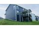 Backyard view of the house featuring vinyl siding, a spacious lawn, and a wooden deck with stairs at 6377 Harvey Dr, Plainfield, IN 46168