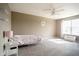 Large, carpeted bedroom with a ceiling fan, neutral walls and a big window at 6377 Harvey Dr, Plainfield, IN 46168
