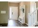 Welcoming entryway with wood floors, white storage bench, and a view of the staircase at 6377 Harvey Dr, Plainfield, IN 46168