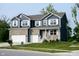 Charming two-story home featuring a brick and vinyl exterior, a two-car garage, and a well-manicured front lawn at 6377 Harvey Dr, Plainfield, IN 46168