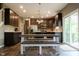 Kitchen with wooden cabinets, stainless appliances, island and view to outside patio at 6377 Harvey Dr, Plainfield, IN 46168