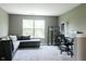Comfortable living room featuring a gray sofa, a large window, and a desk area at 6377 Harvey Dr, Plainfield, IN 46168