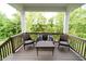 Covered patio with outdoor seating and view of the landscaped backyard with mature trees at 6377 Harvey Dr, Plainfield, IN 46168