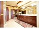 Elegant bathroom with a long vanity, a walk-in shower, and an entrance to the Primary bedroom at 6412 Fall Creek Rd, Indianapolis, IN 46220