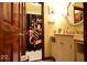 This bathroom has a bright vanity, a round mirror, and a shower with a themed curtain at 6412 Fall Creek Rd, Indianapolis, IN 46220
