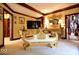 Comfortable bedroom seating with ornately carved gold bench and other antique decorations at 6412 Fall Creek Rd, Indianapolis, IN 46220