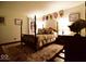 Well-appointed bedroom with a four poster bed, wood floors, and shield decor on the walls at 6412 Fall Creek Rd, Indianapolis, IN 46220