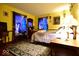 This cozy bedroom offers a comfortable bed, unique decor, and warm, inviting colors at 6412 Fall Creek Rd, Indianapolis, IN 46220