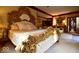 Lavish bedroom featuring a large ornate gold bed frame, providing an opulent and luxurious feel to the space at 6412 Fall Creek Rd, Indianapolis, IN 46220