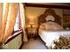 Opulent bedroom with an ornate headboard, plush bedding, and a stylish nightstand, creating a luxurious retreat at 6412 Fall Creek Rd, Indianapolis, IN 46220