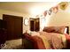 Comfortable bedroom with a closet and a warm color scheme at 6412 Fall Creek Rd, Indianapolis, IN 46220