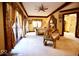 Expansive bedroom featuring a gold ornamented bench, with a view into the ensuite bathroom at 6412 Fall Creek Rd, Indianapolis, IN 46220