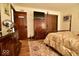 Nicely decorated bedroom with dark wood furniture, light-colored walls, and hardwood floors at 6412 Fall Creek Rd, Indianapolis, IN 46220